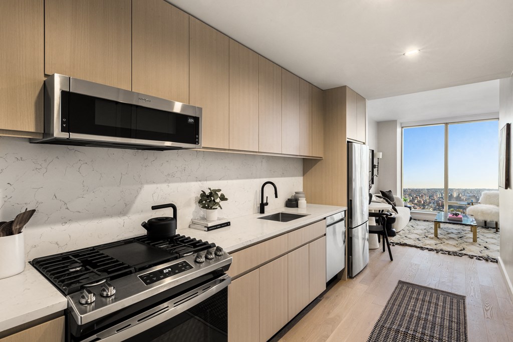 a kitchen with a stove and a sink and a refrigerator at The Paxton, New york